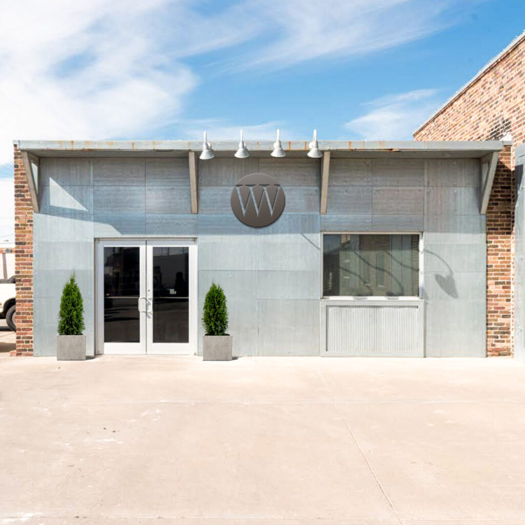 Wells-Warehouse-Building-Side-Larger-with-Sign-and-Trees-downsized-sq